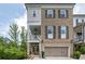 Charming two-story brick home featuring a covered porch and a two-car garage at 385 Rowes Cir, Alpharetta, GA 30009
