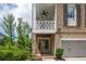 Traditional brick home with covered porch, black shutters, and a two-car garage at 385 Rowes Cir, Alpharetta, GA 30009