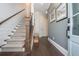 An elegant foyer with hardwood floors, stylish stairway and runner, designer paint, and bright lighting at 385 Rowes Cir, Alpharetta, GA 30009