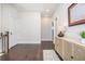 Bright hallway featuring hardwood floors, white walls, and a stylish console table with modern decor at 385 Rowes Cir, Alpharetta, GA 30009