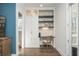 Bright home office with custom built-in shelving and a dedicated workspace at 385 Rowes Cir, Alpharetta, GA 30009