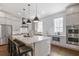 Modern kitchen with stainless steel appliances, a large center island, and sleek countertops at 385 Rowes Cir, Alpharetta, GA 30009