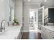 Bright kitchen featuring white cabinets, stainless appliances, and access to a screened porch at 385 Rowes Cir, Alpharetta, GA 30009