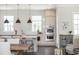 Modern kitchen with stainless steel double ovens, white cabinets, and a cozy breakfast nook at 385 Rowes Cir, Alpharetta, GA 30009