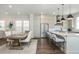 Bright kitchen with stainless steel appliances, white countertops and cabinetry, and island seating at 385 Rowes Cir, Alpharetta, GA 30009