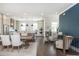 Open concept living and dining area with hardwood floors and natural light in neutral tones at 385 Rowes Cir, Alpharetta, GA 30009