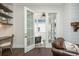 Cozy living room with built-in shelves and open French doors to the outdoor patio at 385 Rowes Cir, Alpharetta, GA 30009