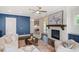 Bright living room featuring a fireplace, ceiling fan, dark wood floors, and stylish decor at 385 Rowes Cir, Alpharetta, GA 30009