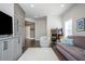 Entertainment room features hardwood floors, a sofa, arcade games, and custom cabinets at 385 Rowes Cir, Alpharetta, GA 30009