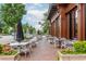 Charming outdoor restaurant seating area with umbrellas, tables, and chairs on a brick patio at 385 Rowes Cir, Alpharetta, GA 30009