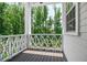 Cozy porch with decorative railing and views of lush greenery at 385 Rowes Cir, Alpharetta, GA 30009