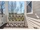 Charming side porch with decorative railing, showcasing the home's exterior and natural light at 385 Rowes Cir, Alpharetta, GA 30009