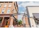 Street view of shops and restaurants with brick sidewalks and ironwork details on buildings at 385 Rowes Cir, Alpharetta, GA 30009