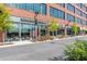 Commercial building with large glass windows, well-lit shops, and street foliage at 385 Rowes Cir, Alpharetta, GA 30009