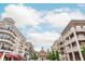 Street view with traditional brick buildings, storefronts, balconies and streetlamps on a sunny day at 385 Rowes Cir, Alpharetta, GA 30009