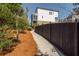 The property's side yard features a well-maintained walkway next to a privacy fence at 385 Rowes Cir, Alpharetta, GA 30009