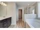 Bathroom featuring a modern vanity, separate tub, glass-enclosed shower, and natural light at 4594 Eastbrook Pl, Snellville, GA 30039