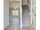 Bright entryway with wood floors, staircase, and view of the living area with large windows at 4594 Eastbrook Pl, Snellville, GA 30039