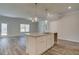 Kitchen island with granite countertop and stainless steel sink overlooking the living area at 4594 Eastbrook Pl, Snellville, GA 30039