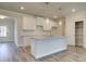 Kitchen island with white cabinets, granite countertops, and stainless steel sink at 4594 Eastbrook Pl, Snellville, GA 30039