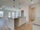 An updated kitchen with a granite countertop island, pendant lights, and stainless steel sink at 4594 Eastbrook Pl, Snellville, GA 30039