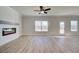 This spacious living room features a modern fireplace, ceiling fan, and sliding glass door to the backyard at 4594 Eastbrook Pl, Snellville, GA 30039