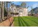 Exterior of home featuring a large manicured lawn and a wooden deck at 1040 Longwood Dr, Woodstock, GA 30189