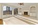 Living room featuring a fireplace, built-in shelving, plush carpet, and access to the outdoor deck at 1040 Longwood Dr, Woodstock, GA 30189