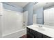 Bathroom features a shower and tub combo, a white vanity, and a dark wood floor at 1761 Brandemere Dr, Austell, GA 30168