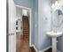Charming half bathroom showcasing a pedestal sink, updated fixtures and stylish design elements at 1761 Brandemere Dr, Austell, GA 30168