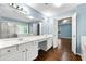 Bathroom features a double vanity, large mirror, glass shower, and hardwood floors at 1761 Brandemere Dr, Austell, GA 30168