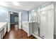 Bathroom features a glass enclosed shower, large tub, and hardwood floors at 1761 Brandemere Dr, Austell, GA 30168