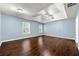 This bedroom features hardwood floors, blue painted walls, and a ceiling fan at 1761 Brandemere Dr, Austell, GA 30168