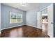 Cozy bedroom features hardwood floors, natural light, and access to the kitchen at 1761 Brandemere Dr, Austell, GA 30168