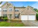 Beautiful brick home featuring a well-manicured lawn, mature landscaping, and a two-car garage at 1761 Brandemere Dr, Austell, GA 30168