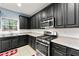 Well-equipped kitchen boasts stainless steel appliances, granite countertops, and ample cabinet space at 1761 Brandemere Dr, Austell, GA 30168