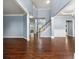 Bright living room featuring hardwood floors, a staircase, and large windows with abundant natural light at 1761 Brandemere Dr, Austell, GA 30168