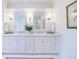 Bathroom boasting a double vanity with white marble countertops, storage, and chrome fixtures at 479 Argonne Nw Dr, Atlanta, GA 30305