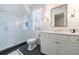 This bright bathroom features a glass enclosed shower and a vanity with marble counters at 479 Argonne Nw Dr, Atlanta, GA 30305