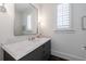 This powder room features a white marble countertop, chrome fixtures, and a large mirror at 479 Argonne Nw Dr, Atlanta, GA 30305