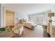 A bright bedroom with hardwood floors features a plush bed, sitting area, and natural light at 479 Argonne Nw Dr, Atlanta, GA 30305