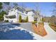 View of a gray two-story home featuring a three-car garage and a landscaped yard at 479 Argonne Nw Dr, Atlanta, GA 30305