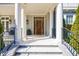 Inviting front porch with stone steps, elegant pillars, and a dark wood door at 479 Argonne Nw Dr, Atlanta, GA 30305