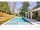 Swimming pool with an integrated spa in a backyard with covered patio and lush landscaping at 479 Argonne Nw Dr, Atlanta, GA 30305