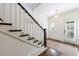 Elegant staircase with dark wood steps, white risers and trim, and a natural fiber rug at the landing at 479 Argonne Nw Dr, Atlanta, GA 30305