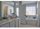 Bathroom with double vanity, soaking tub, and plenty of natural light at 401 Iona Abbey Se Ct # 6, Smyrna, GA 30082