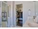 Bathroom featuring double sinks, a glass door shower, and an open walk-in closet at 401 Iona Abbey Se Ct # 6, Smyrna, GA 30082