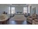 Bright bedroom with two windows, hardwood floors, and a comfortable seating area at 401 Iona Abbey Se Ct # 6, Smyrna, GA 30082