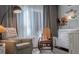 Cozy Bedroom with rocking chair, curtains, and white changing table at 401 Iona Abbey Se Ct # 6, Smyrna, GA 30082