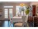Bright dining room with hardwood floors, chandelier lighting, and large windows at 401 Iona Abbey Se Ct # 6, Smyrna, GA 30082